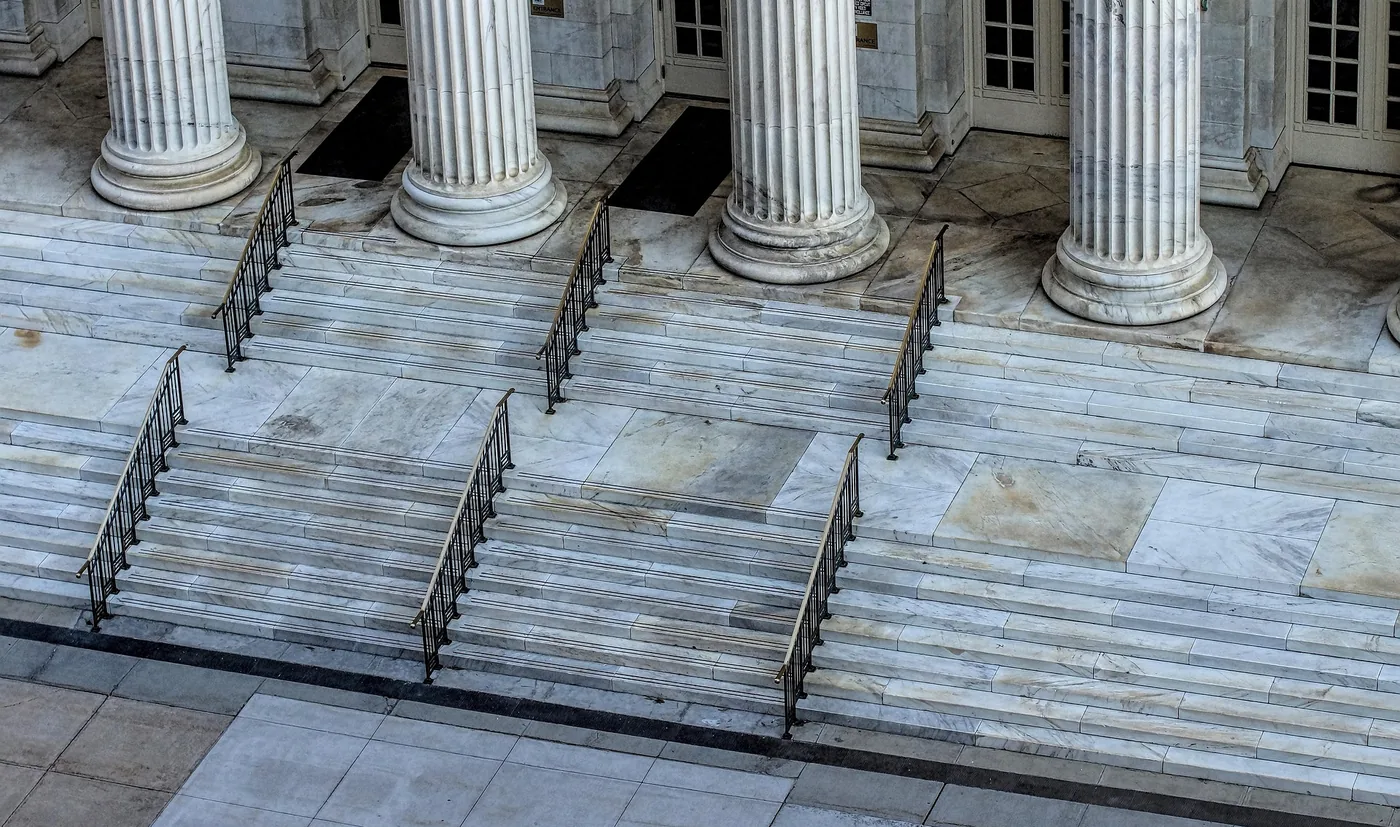 Marble steps rising to a row of fluted columns