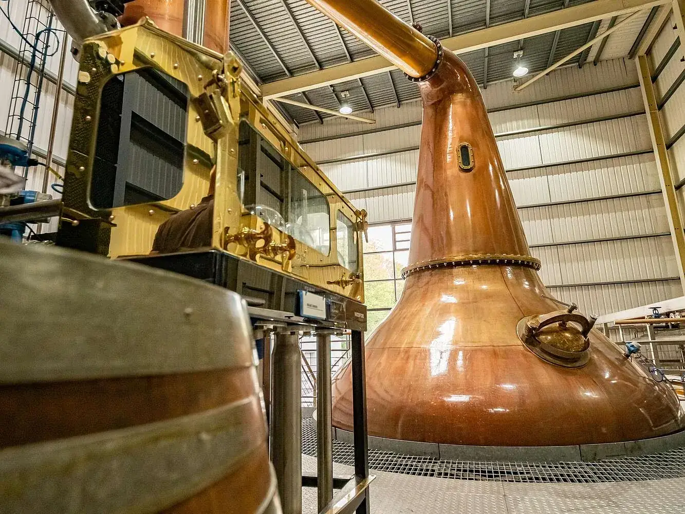 The gleaming copper pot stills and brass spirit safe inside Waterford Distillery