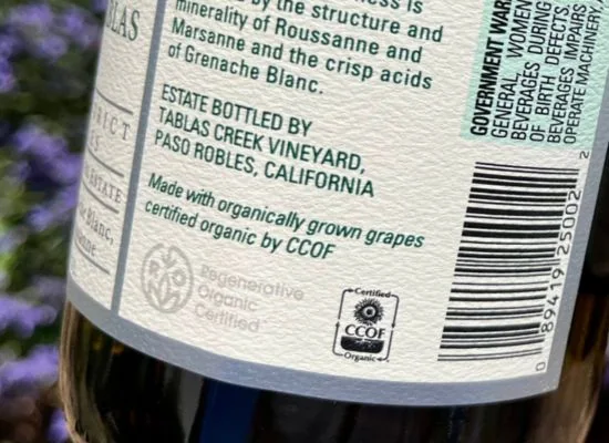 Back label of a Tablas Creek bottle showing the CCOF Certified Organic and Regenerative Organic Certified marks